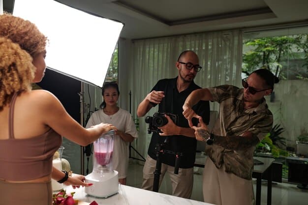 A behind-the-scenes shot of a diverse cast and crew filming a drama series episode. The director is giving instructions, and the actors are in costume.