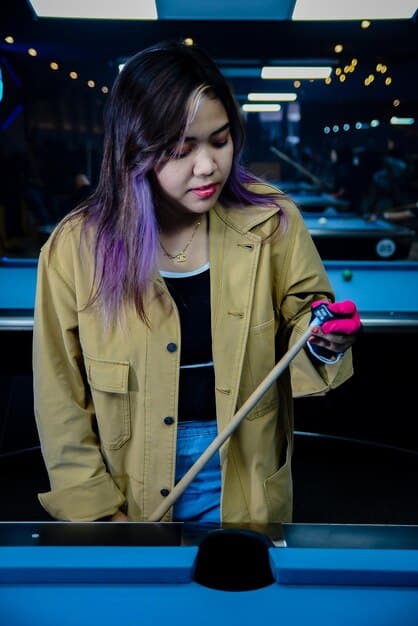 An eye-level shot of a reality TV star creating a TikTok video in a well-lit studio, showcasing a new product from their business. The shot includes social media icons and enthusiastic comments filling the screen.