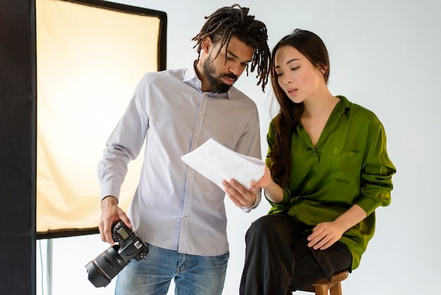 Two casting directors sitting at a table, reviewing audition tapes and smiling at each other. The scene suggests they have found a promising candidate.