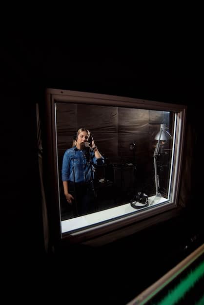 A reality TV contestant in a confessional booth, expressing a mix of vulnerability and determination, with soft lighting highlighting their emotional state.