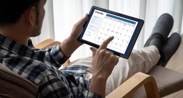 A person using a tablet with a calendar app open, showing specific colored blocks for 