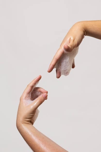 A close-up of a hand gently massaging a foaming cleanser onto a person's face, illustrating the second step of the K-beauty double cleanse. The skin looks clean and fresh.