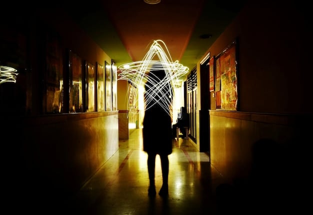 A shadowy figure resembling Principal Weems, partially obscured, standing in a dimly lit section of Nevermore Academy, creating a sense of mystery and potential spectral return.