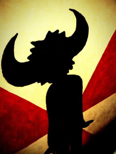 A tattered banner depicting the symbol of Kronos, held by a shadowy figure, with Luke Castellan looking on in contemplation with a conflicted expression.