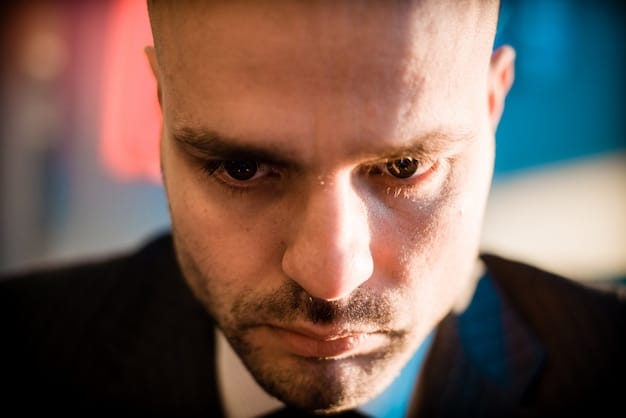 A close-up of a severed employee's face, showing a subtle but unsettling shift in expression, highlighting the internal struggle between innie and outie personalities.