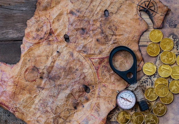 A detailed, old-fashioned treasure map with intricate drawings and cryptic symbols, possibly burned at the edges, lying on a wooden table.