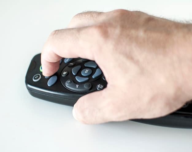 A close-up shot of a remote control in a hand, poised to press play on a streaming service interface, with thumbnails of various trending series visible on the screen. The image focuses on the moment of choosing what to binge-watch.