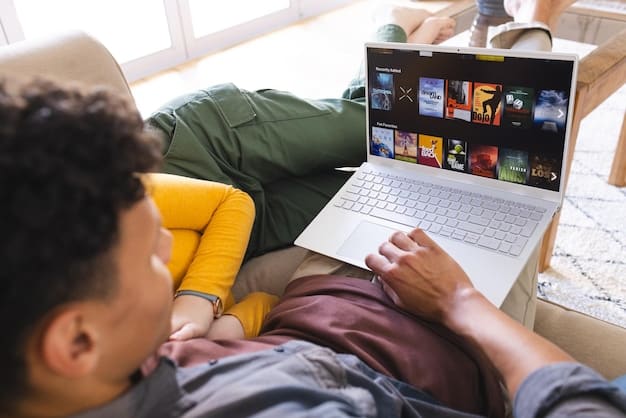 A person browsing a streaming service on a laptop, with various TV series thumbnails displayed on the screen. Their hand is hovering over the 