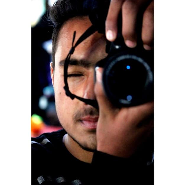 A close-up shot of a K-drama cinematographer adjusting a prime lens on a professional camera, with monitors showing vivid color palettes and crisp focus.