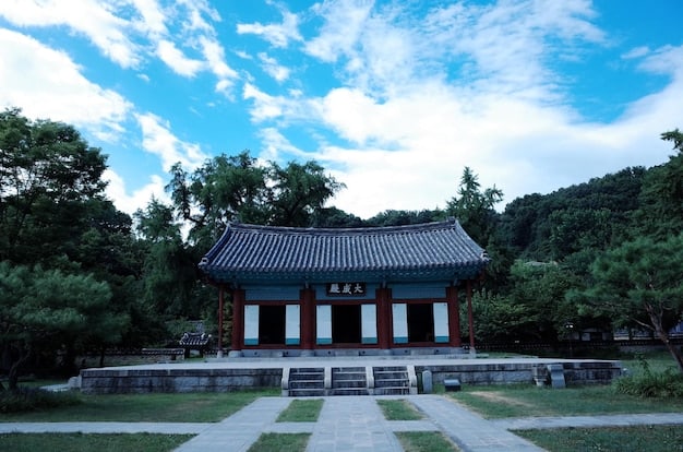 A serene image of Gyeongbokgung Palace in Seoul, South Korea. The palace's traditional architecture is highlighted, with intricate details and vibrant colors. The backdrop features lush greenery and clear blue skies, making the palace appear majestic and inviting as one of the K-Drama Filming Locations You Can Actually Visit: A Virtual Tour of South Korea for US Fans.