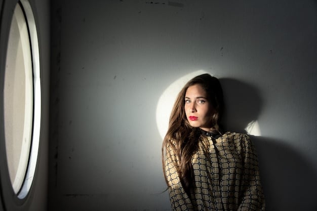 A behind-the-scenes photograph of Jenna Ortega on the set of 'Wednesday', looking serious and focused. The backdrop includes gothic architecture and dark, moody lighting, hinting at the darker themes of 'Wednesday' Season 2: Jenna Ortega Teases Darker Tone and New Addams Family Members Joining the Cast'.
