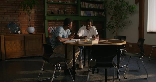 A shot of the writers' room for Halo Season 2, showing a diverse team collaborating and discussing plot points. The scene conveys a sense of dedication to improving the narrative and addressing fan feedback in Halo Season 2.