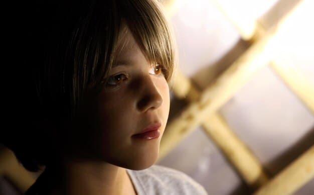 A close-up shot of Gaal Dornick in Foundation Season 3, looking troubled and contemplative. She is surrounded by holographic projections of complex equations, representing the challenges of psychohistory.