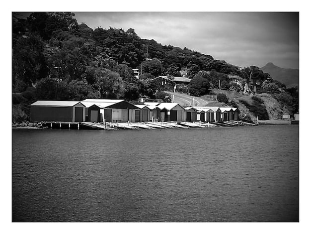 A vintage photograph of the resort's location from the early 20th century, showing a stark contrast between its current luxurious state and its humble beginnings. This could represent past lives and the secrets of 'The White Lotus' Season 3: Will the next group of guests uncover a dark secret hidden within the resort's history?